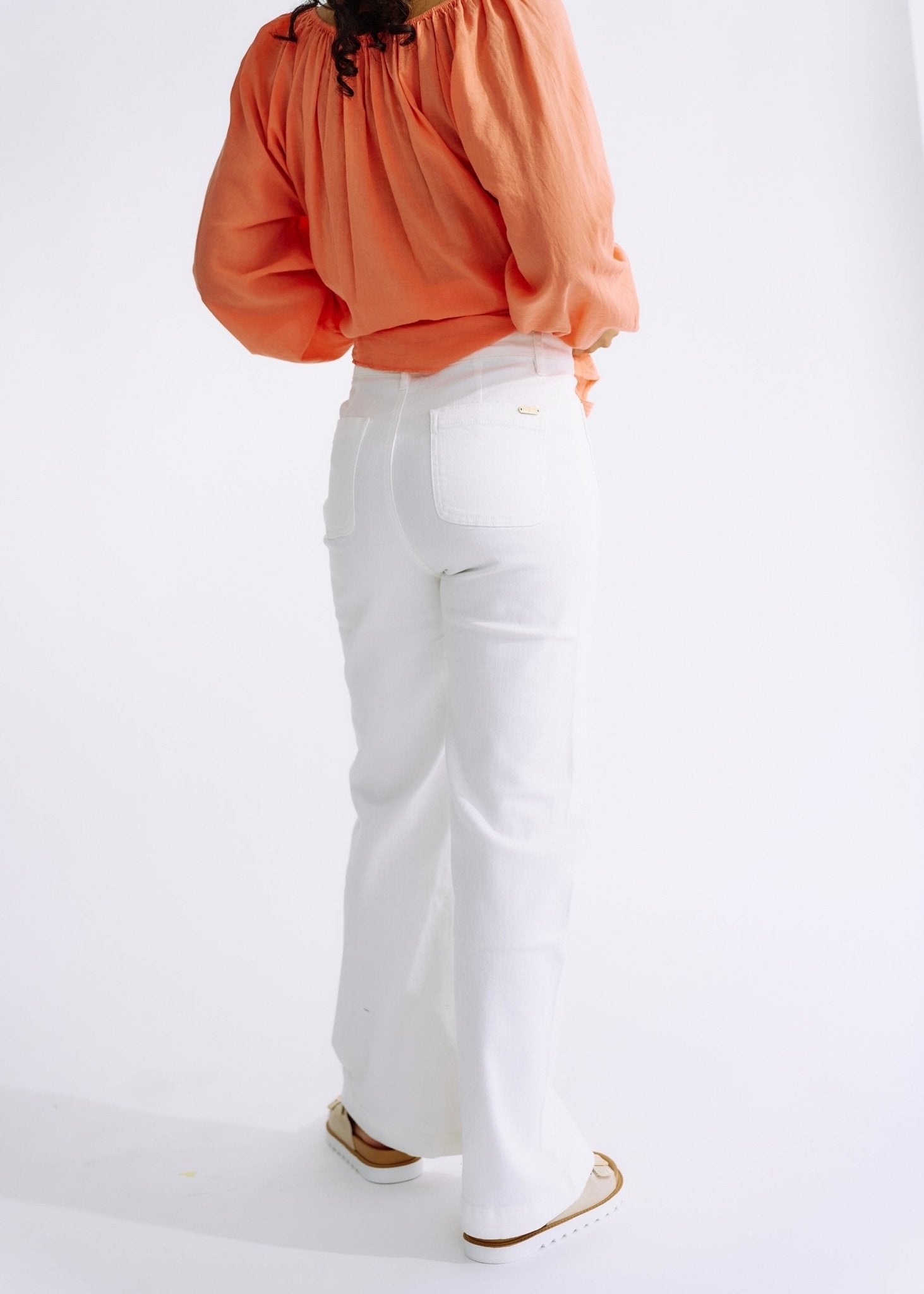 View our High Waisted Flared Jeans in White - The ultimate BOTTOMS created by TRIBUTE and sold here, at Tribute Store