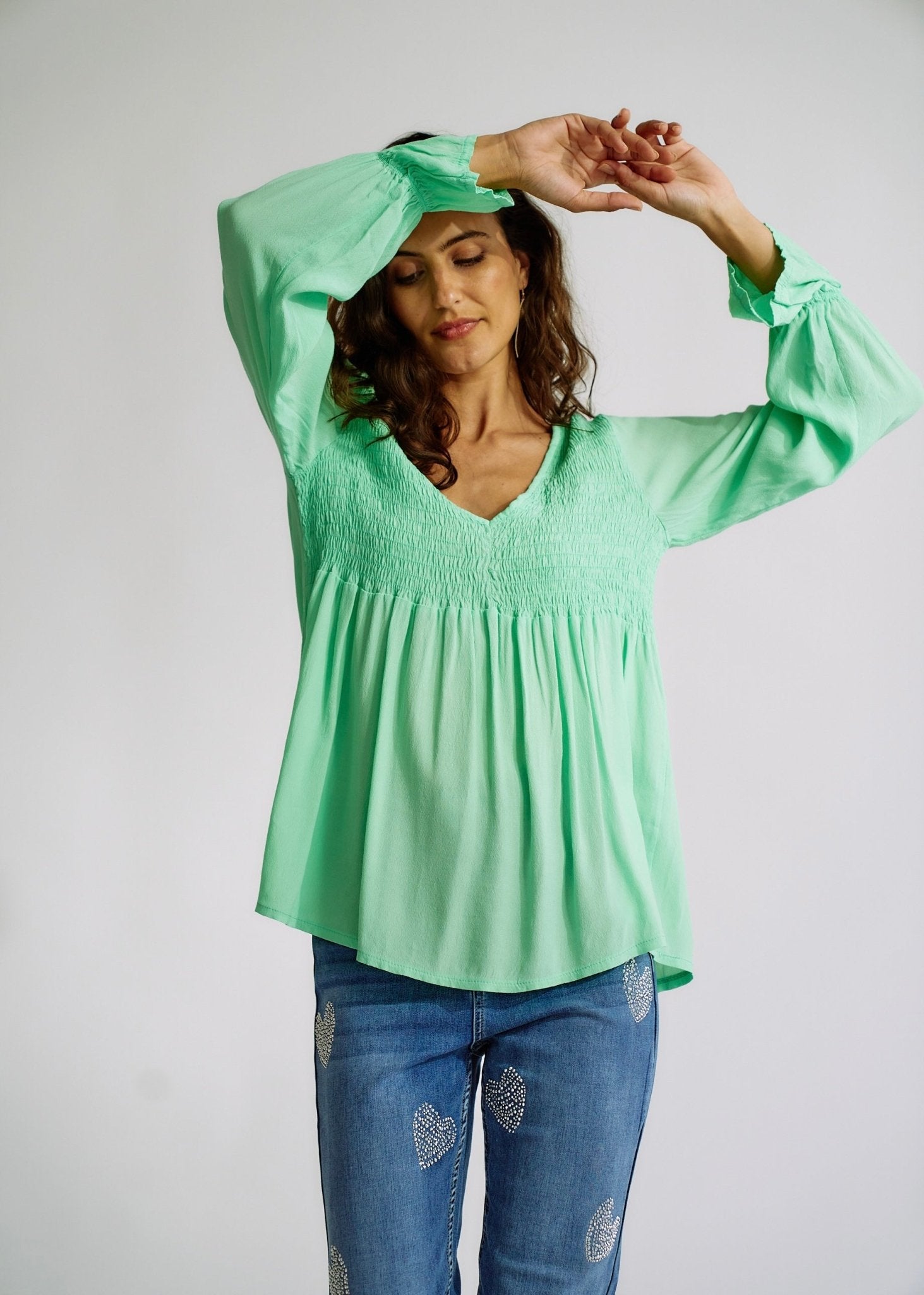 View our Italian Smock V Neck Blouse in Green - The ultimate TOPS created by TRIBUTE and sold here, at Tribute Store