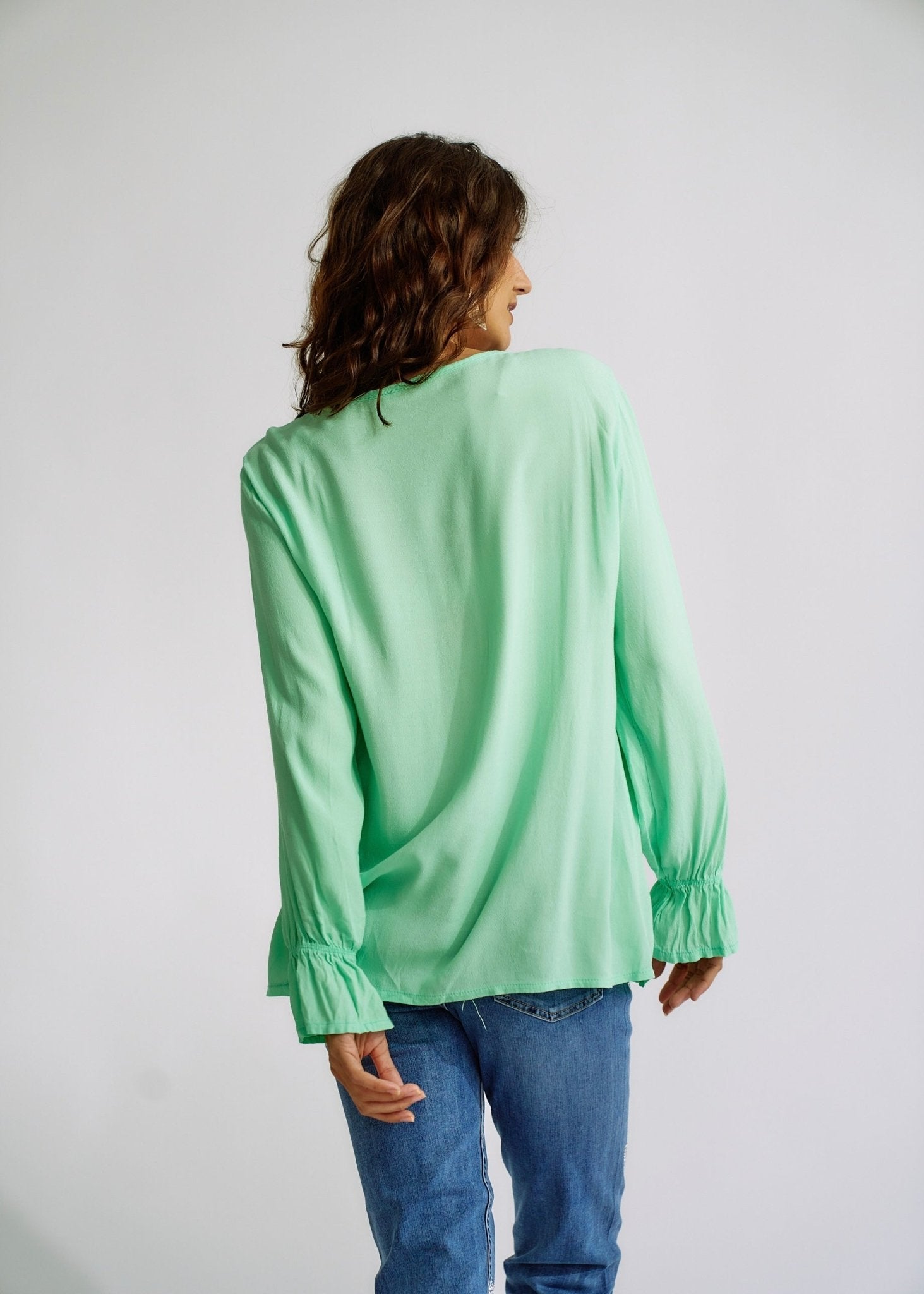 View our Italian Smock V Neck Blouse in Green - The ultimate TOPS created by TRIBUTE and sold here, at Tribute Store