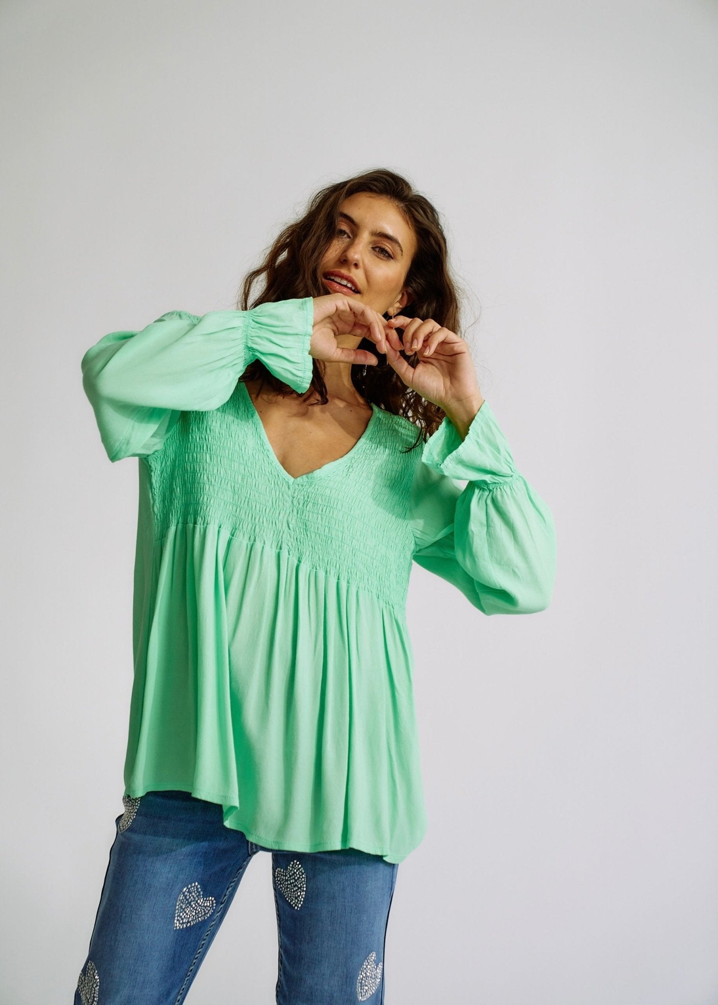 View our Italian Smock V Neck Blouse in Green - The ultimate TOPS created by TRIBUTE and sold here, at Tribute Store