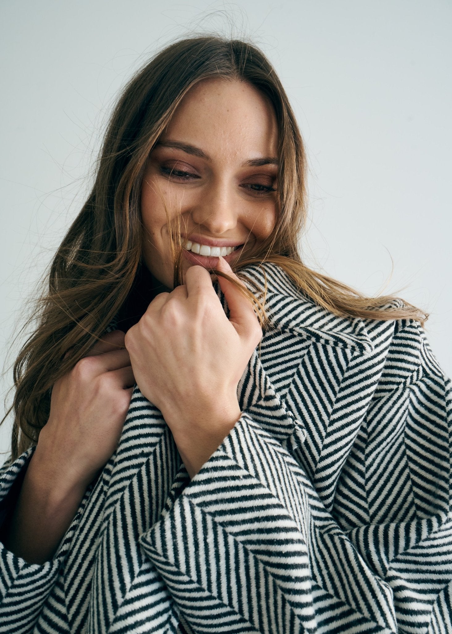 View our Bordeaux Wool Coat in Black and White - by Tribute Store