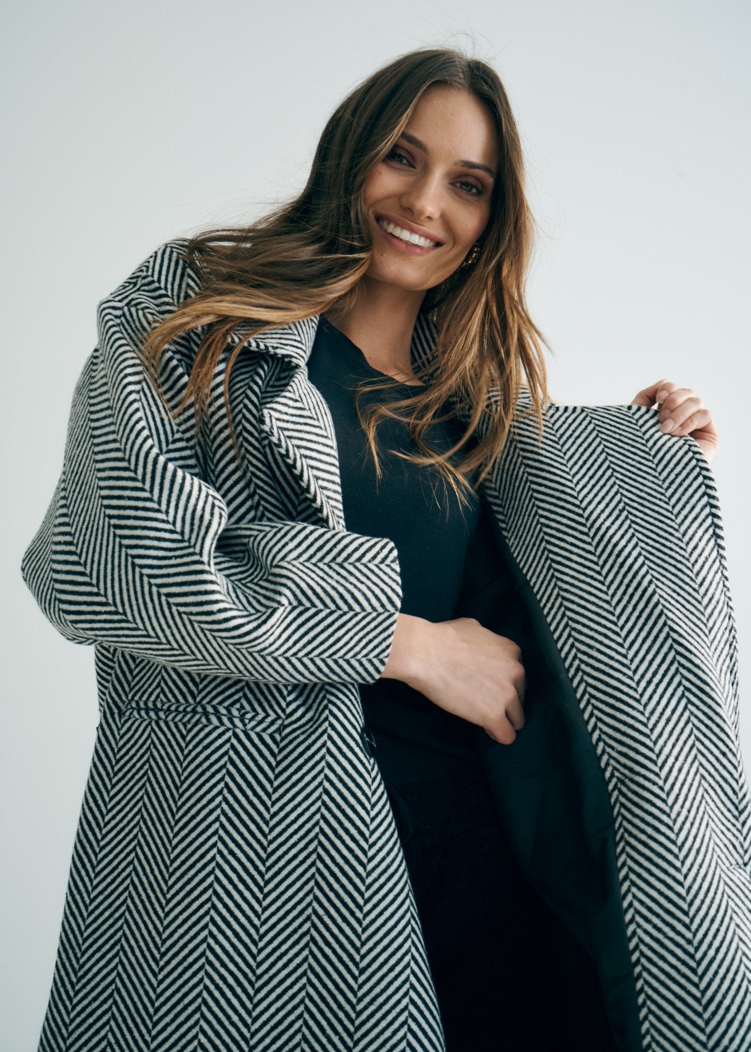 View our Bordeaux Wool Coat in Black and White - by Tribute Store