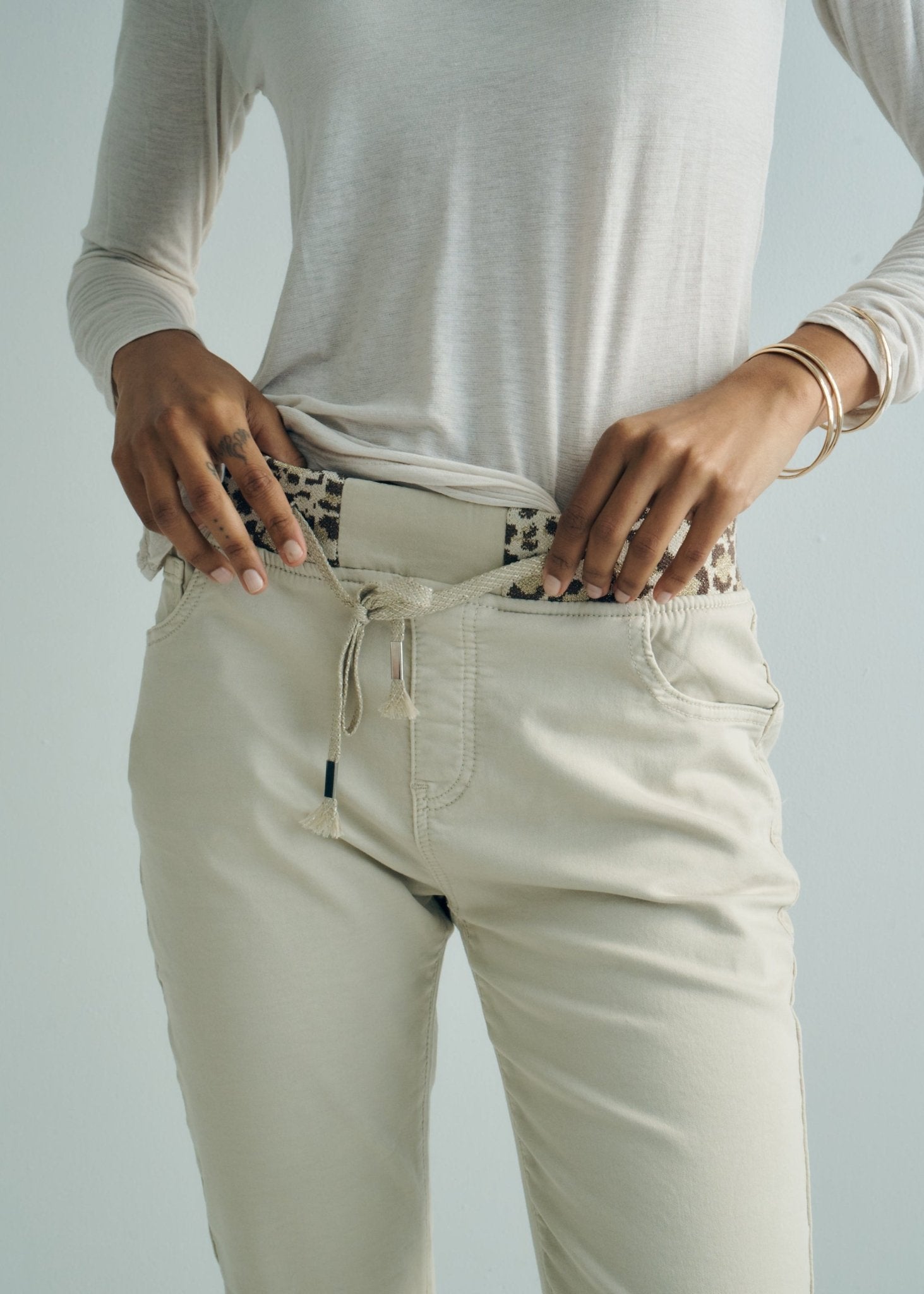 View our Mid - Rise Cotton Jogger Jeans in Beige with Animal Print Waist Band - by Tribute Store