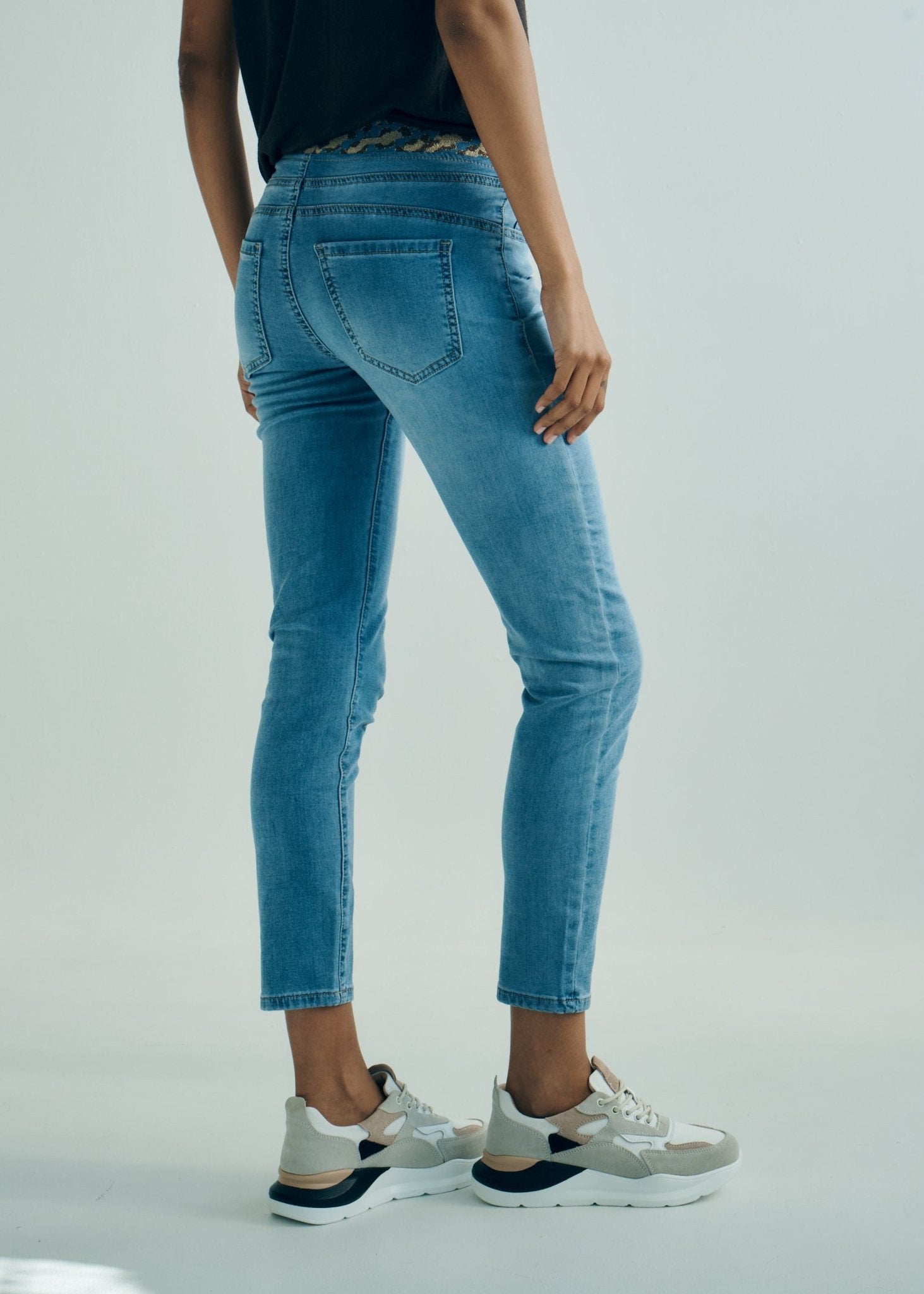 View our Mid - Rise Cotton Jogger Jeans in Blue with Animal Print Waist Band - by Tribute Store