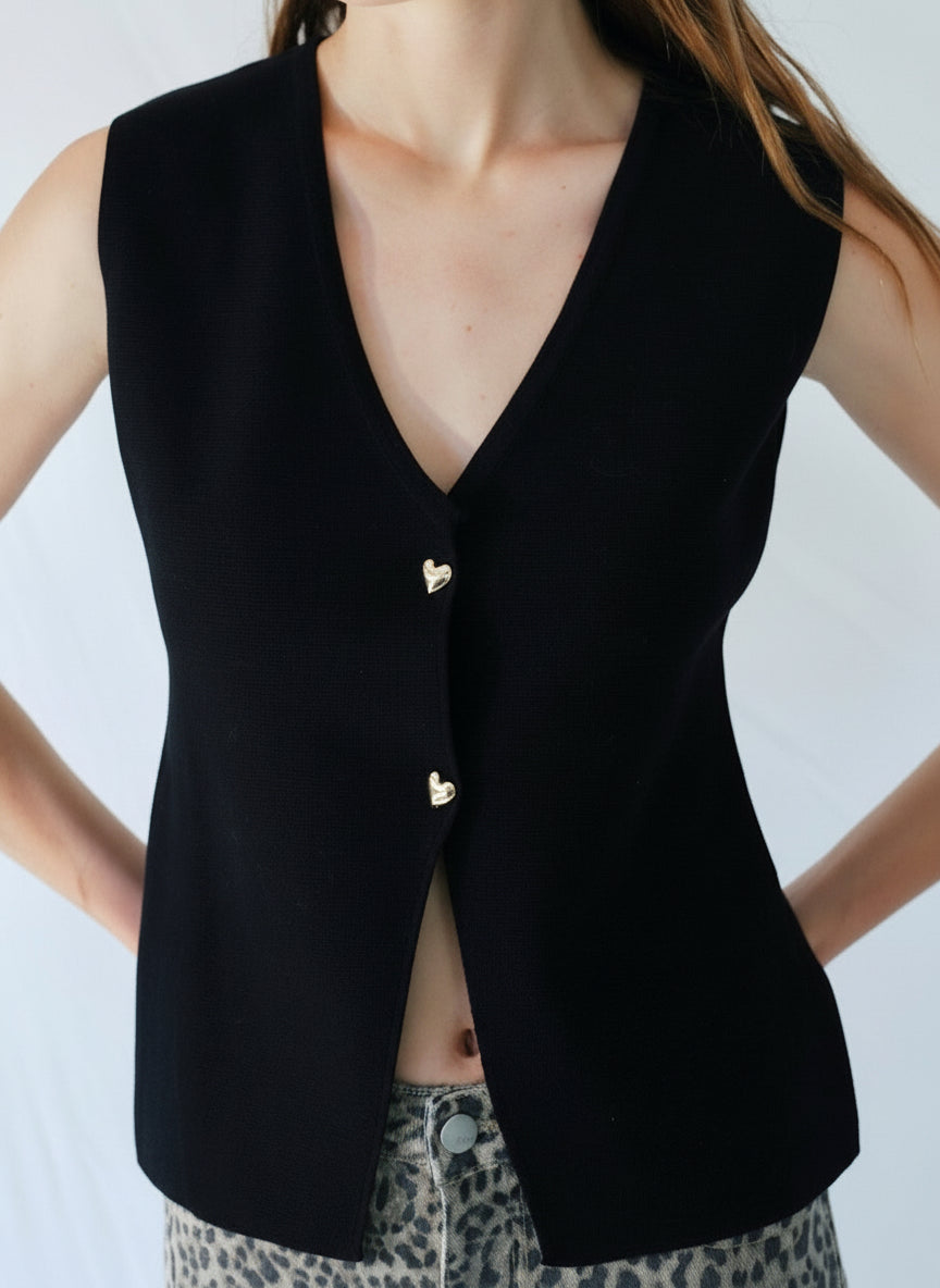 View our Sleeveless Knitted Cardi with Gold Heart Buttons in Black - by Tribute Store