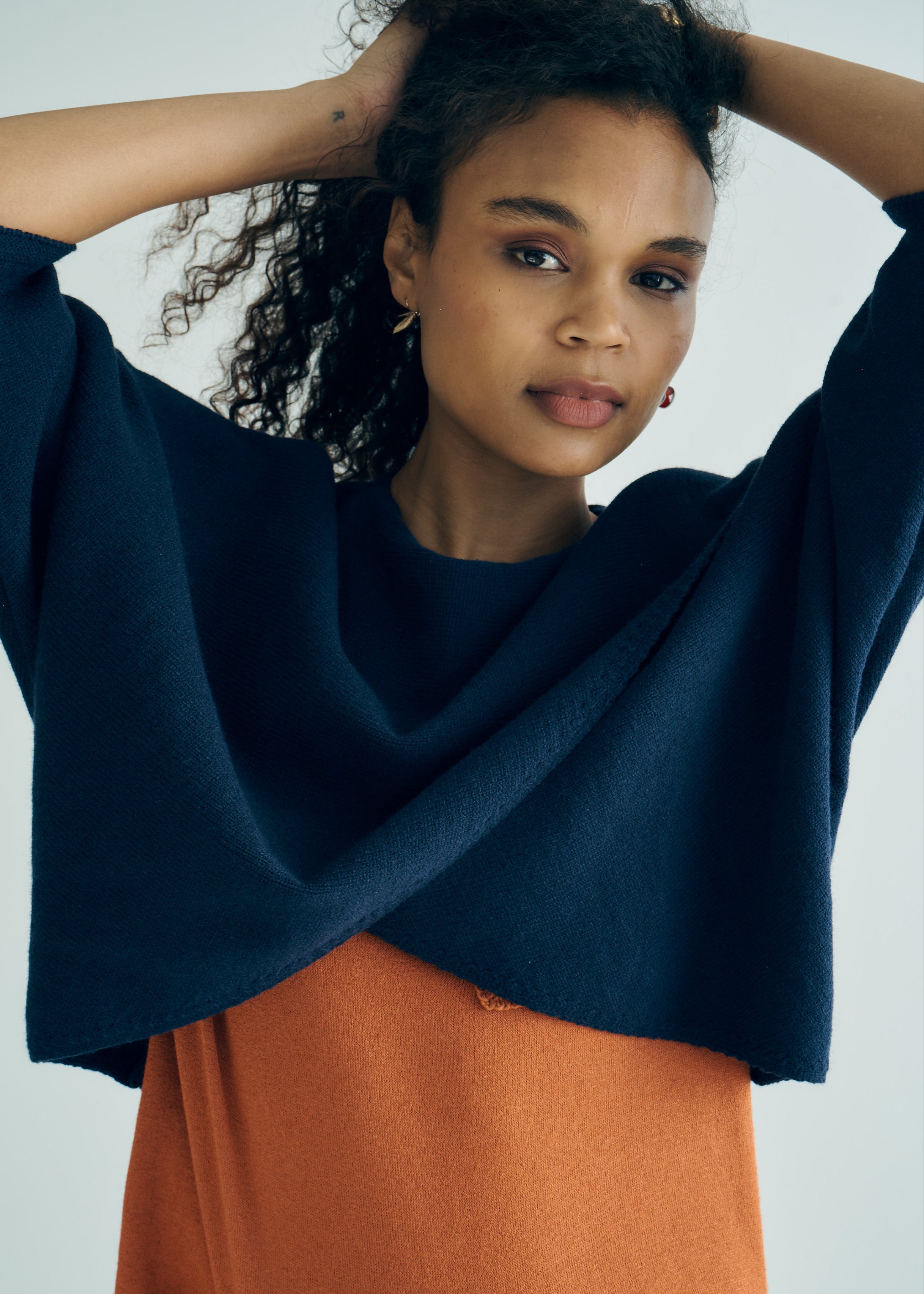 Hygge Italian Viscose Criss Cross Batwing Sleeve Knit In Navy