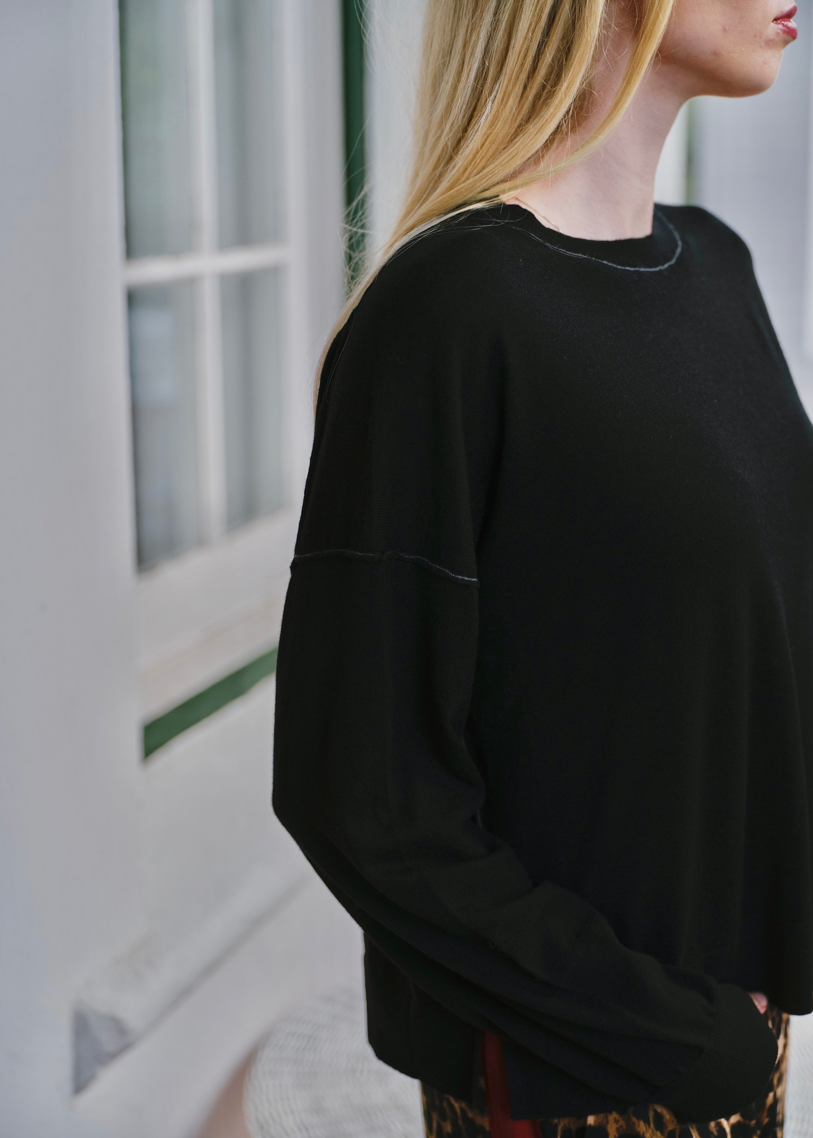 Woman wearing the Irvine wool-blend contrast-stitch knit in black