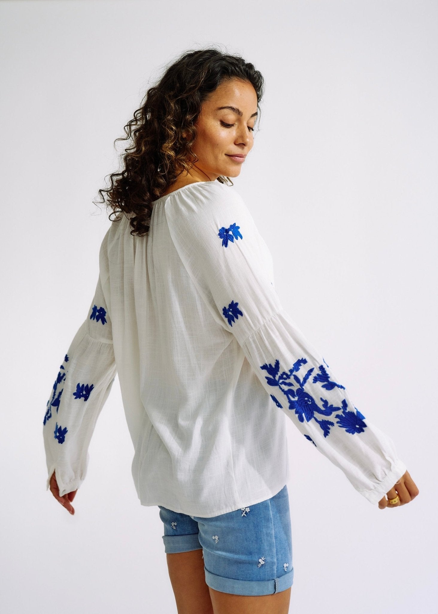 View our Linen Blend Peasant Blouse with Navy Embroidery - The ultimate TOPS created by TRIBUTE and sold here, at Tribute Store