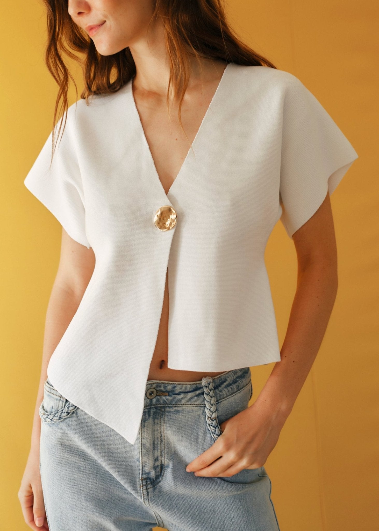 View our Assym Sleeveless Knitted Cardi with Big Gold Button in White - by Tribute Store