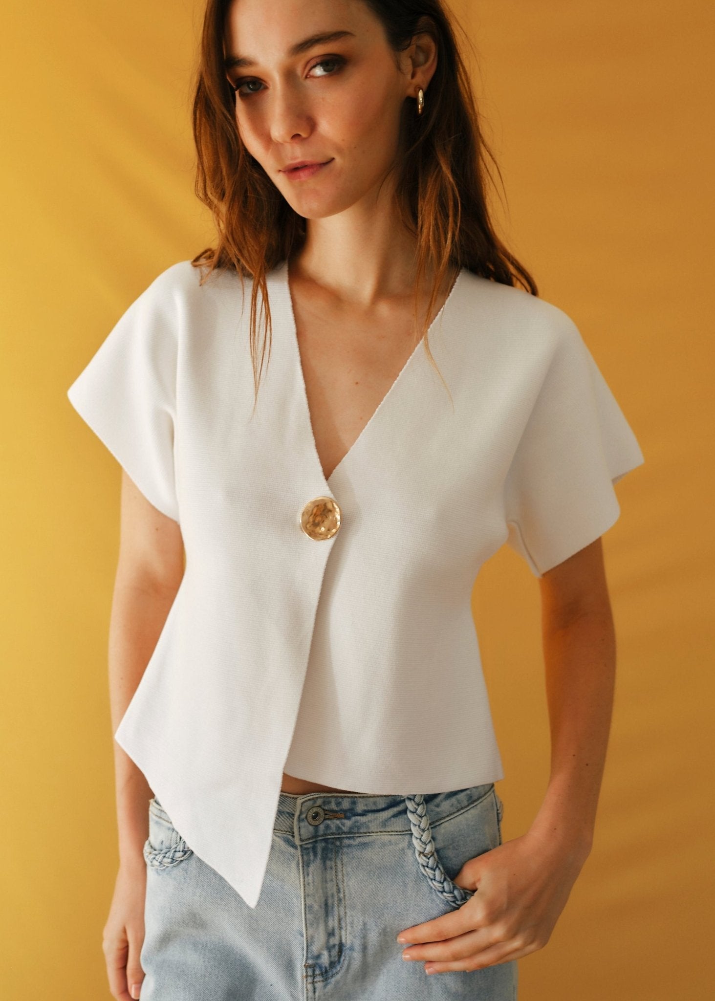 View our Assym Sleeveless Knitted Cardi with Big Gold Button in White - by Tribute Store