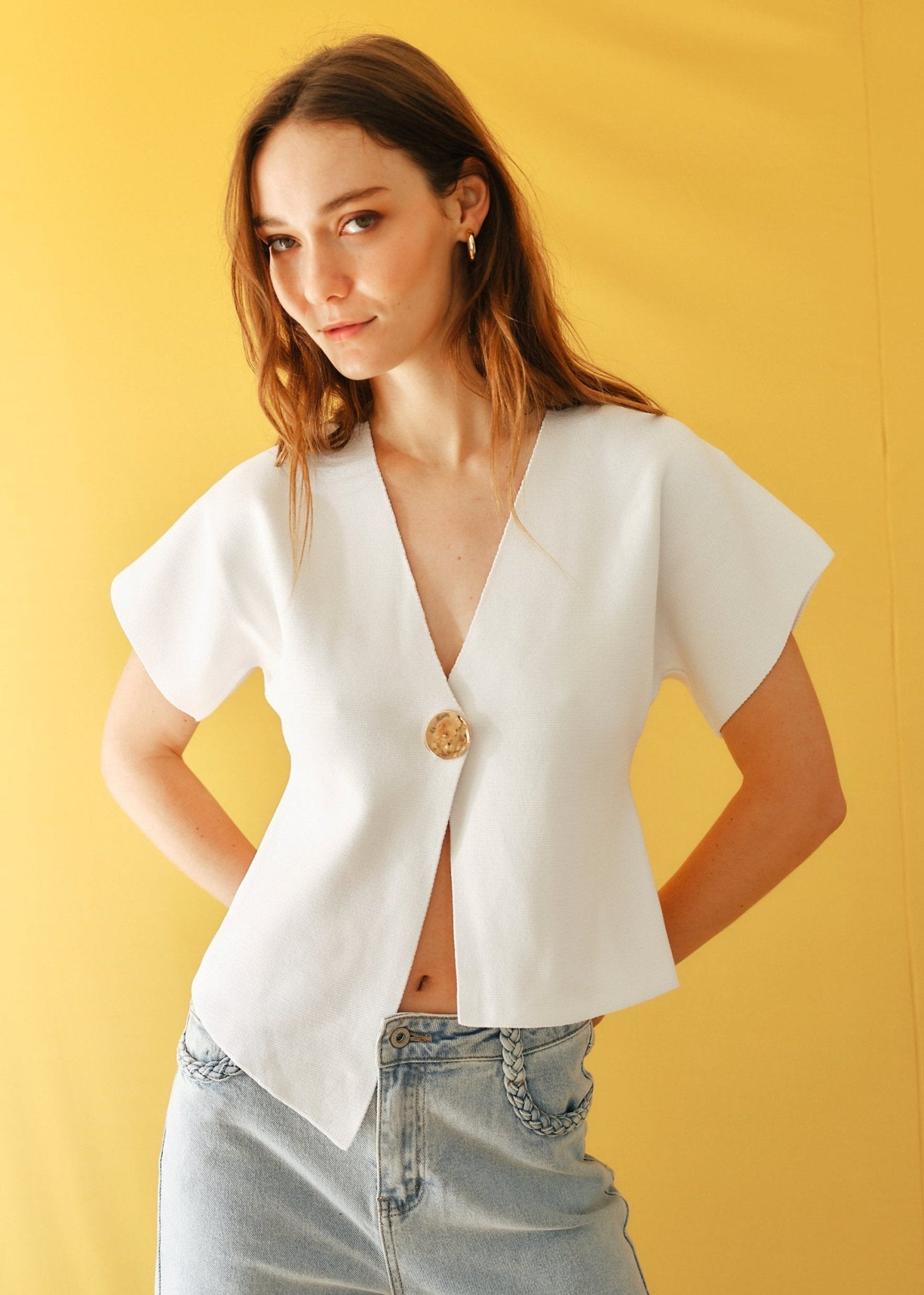 View our Assym Sleeveless Knitted Cardi with Big Gold Button in White - by Tribute Store