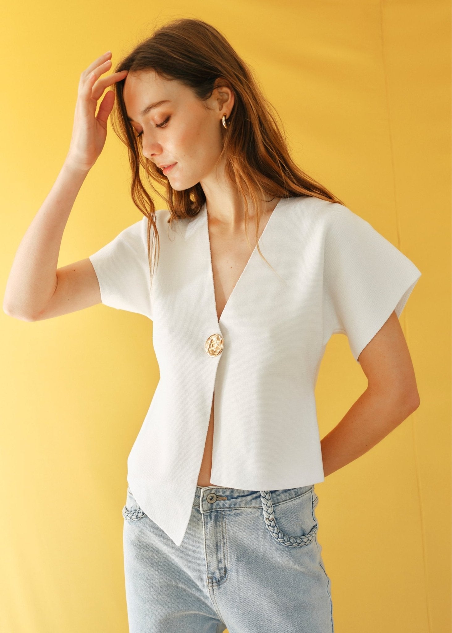 View our Assym Sleeveless Knitted Cardi with Big Gold Button in White - by Tribute Store