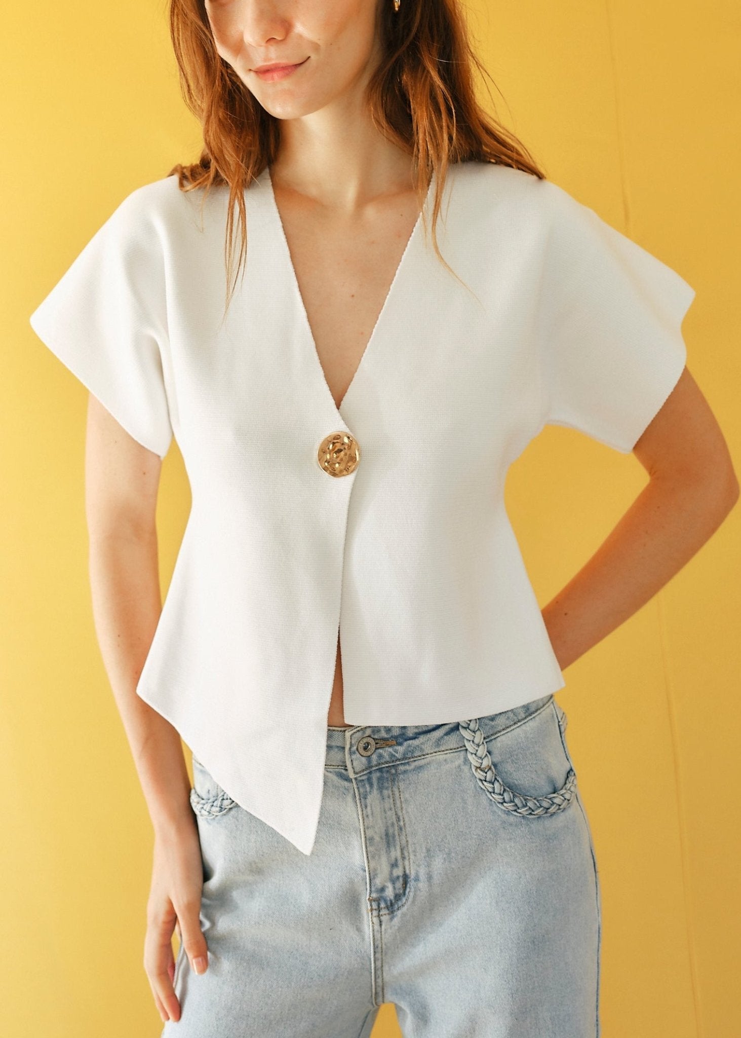 View our Assym Sleeveless Knitted Cardi with Big Gold Button in White - by Tribute Store