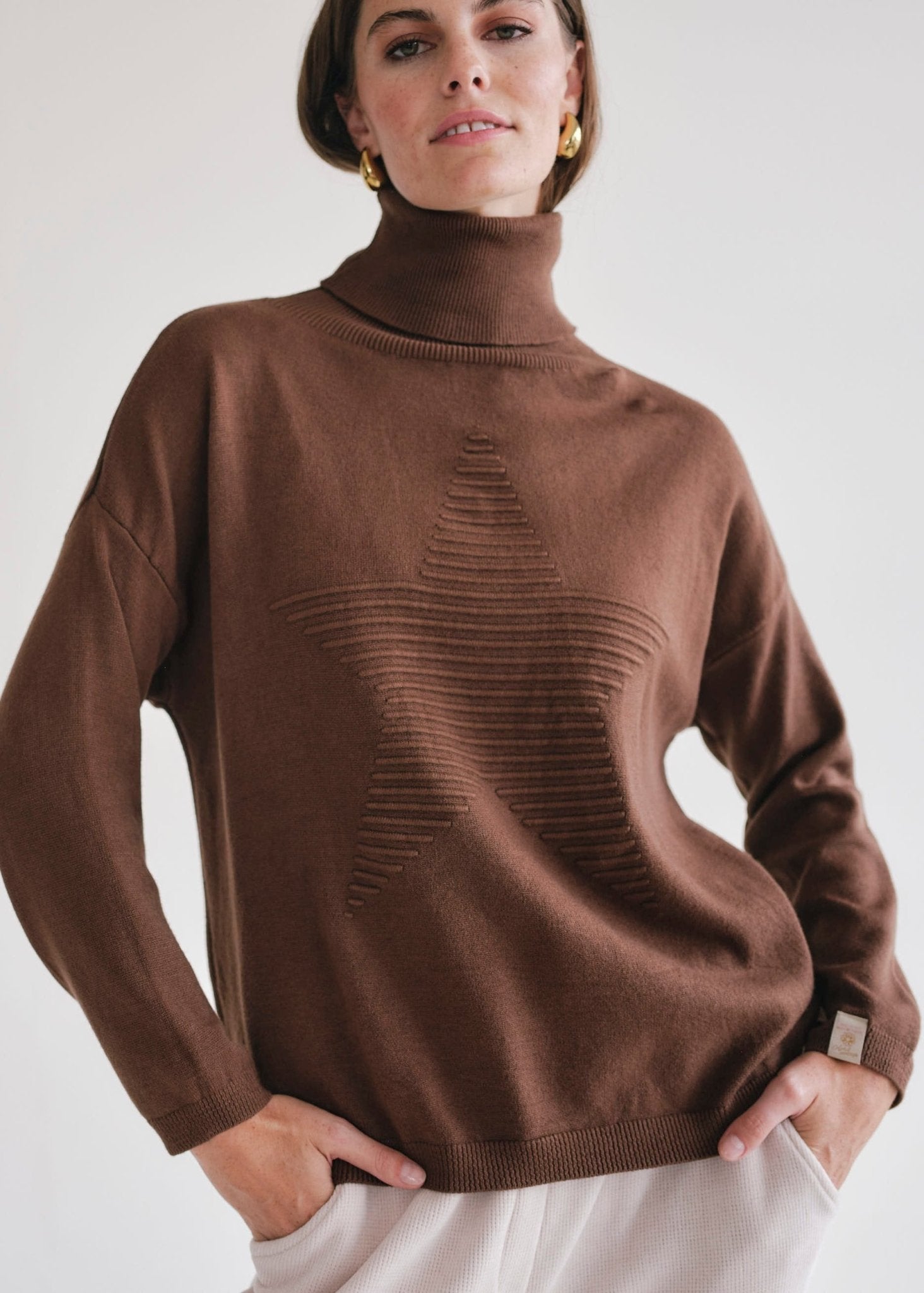 View our Bastille Chocolate Polo Neck Knit with Star front - by Tribute Store