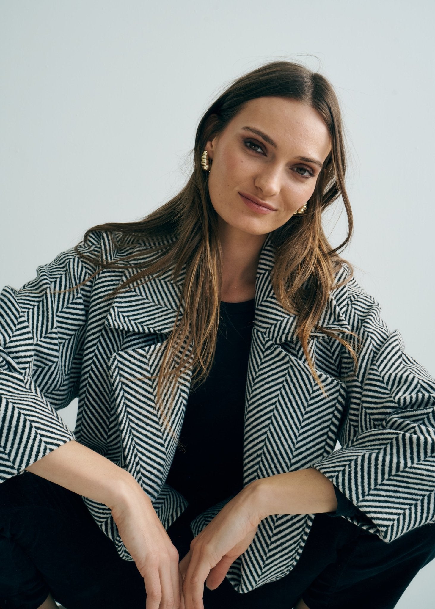 View our Bordeaux Wool Coat in Black and White - by Tribute Store