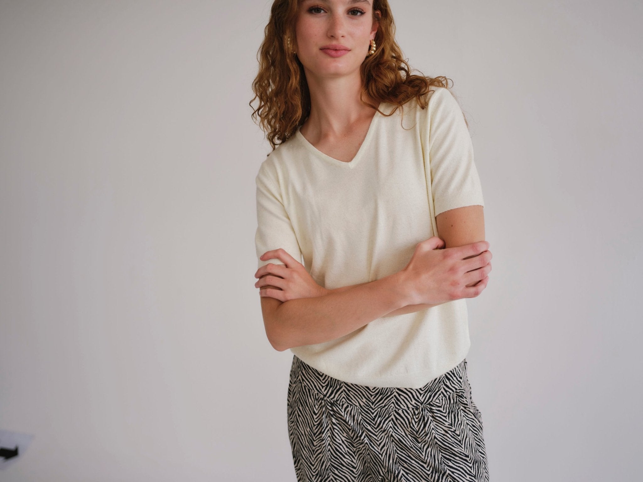 View our Lurex V Neck Tee with Shimmer Detail in Cream - by Tribute Store