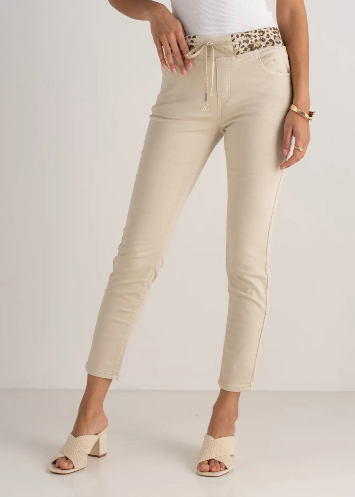 View our Mid - Rise Cotton Jogger Jeans in Beige with Animal Print Waist Band - by Tribute Store