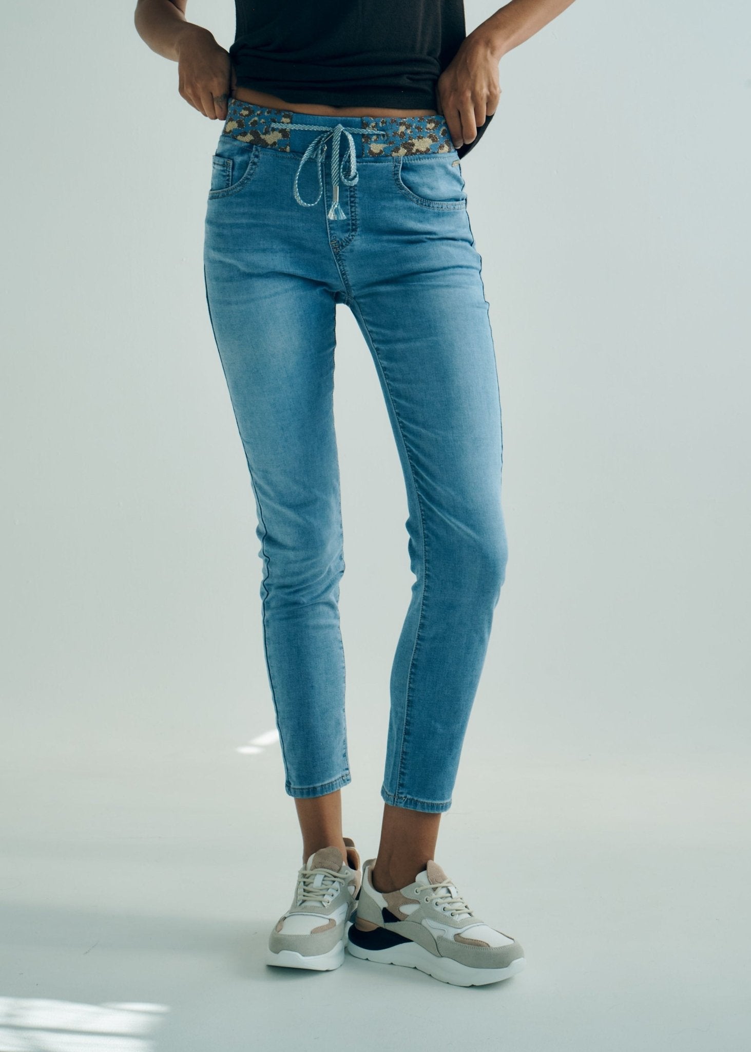 View our Mid - Rise Cotton Jogger Jeans in Blue with Animal Print Waist Band - by Tribute Store