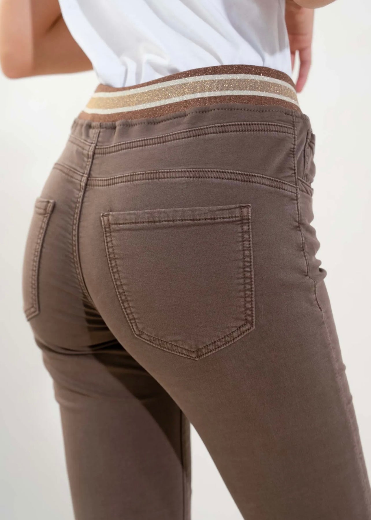 View our Mid - Rise Cotton Jogger Jeans in Chocolate with Gold Waist Band - by Tribute Store