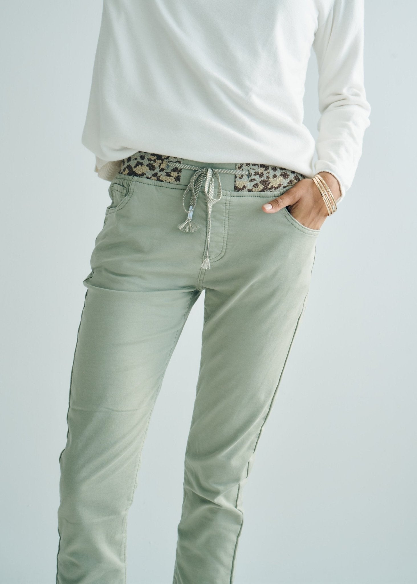 View our Mid - Rise Cotton Jogger Jeans in Khaki with Animal Print Waist Band - by Tribute Store