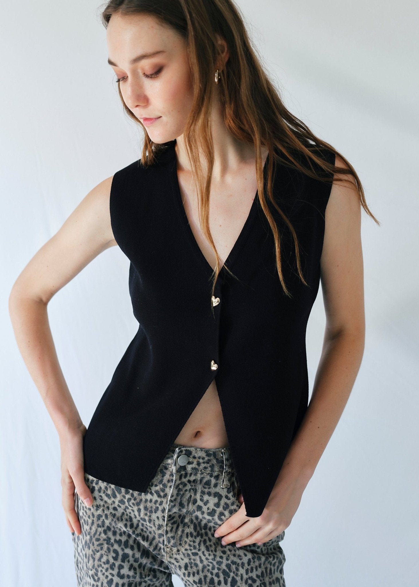 View our Sleeveless Knitted Cardi with Gold Heart Buttons in Black - by Tribute Store